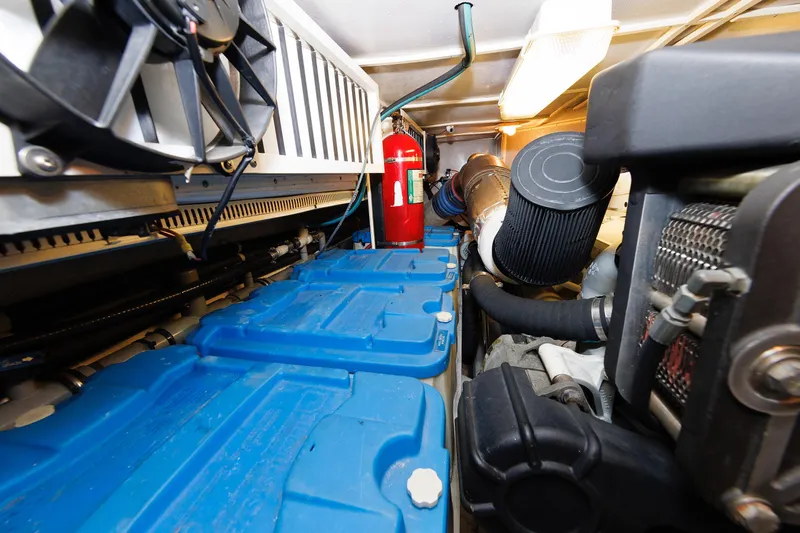 Independence Yacht Photos Pics Engine room of 2009 Hunt Yachts 52 Express, featuring batteries and fire extinguisher.