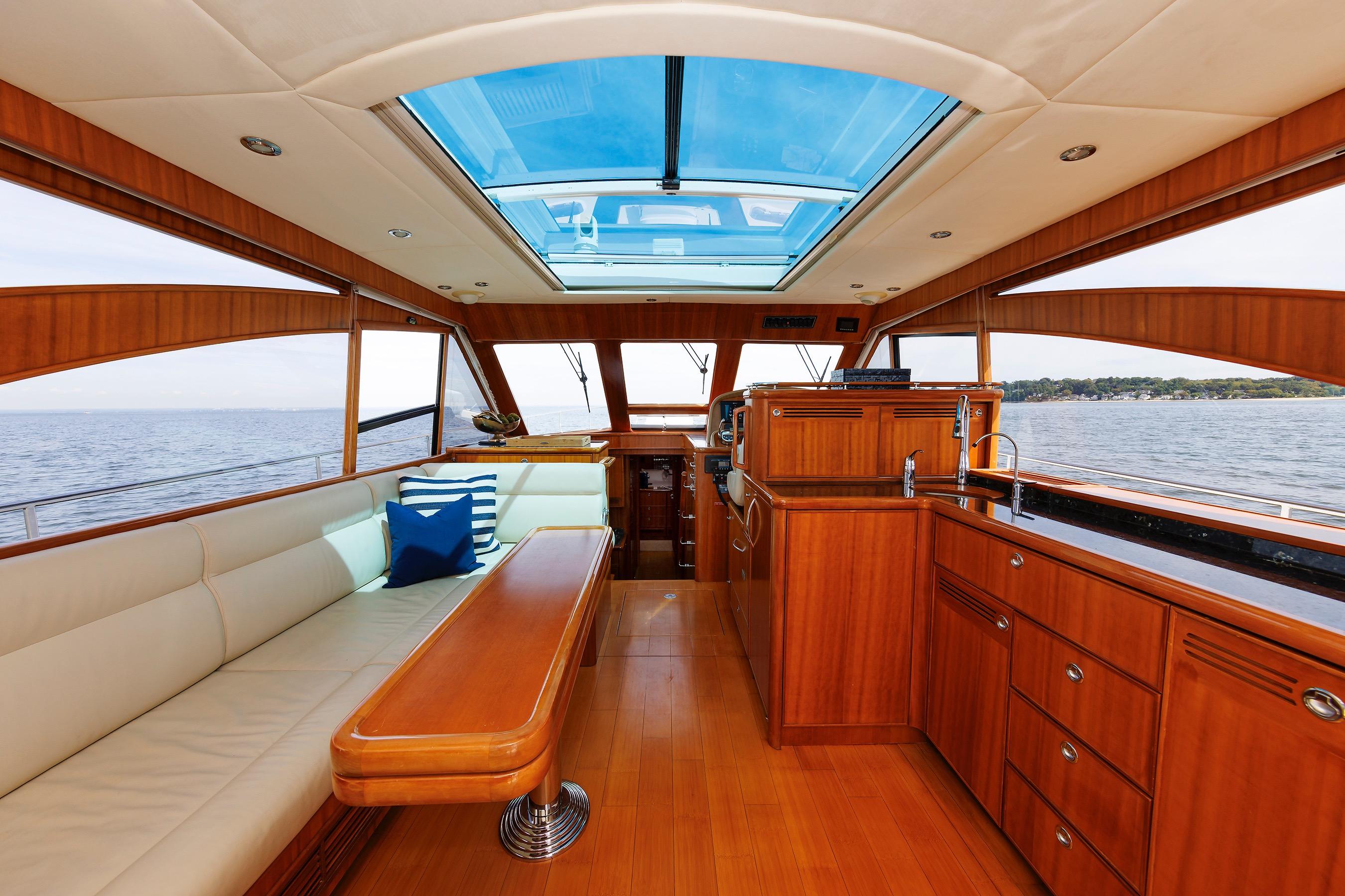 Luxurious interior of 2009 Hunt Yachts 52 Express with wood finish and ocean view.