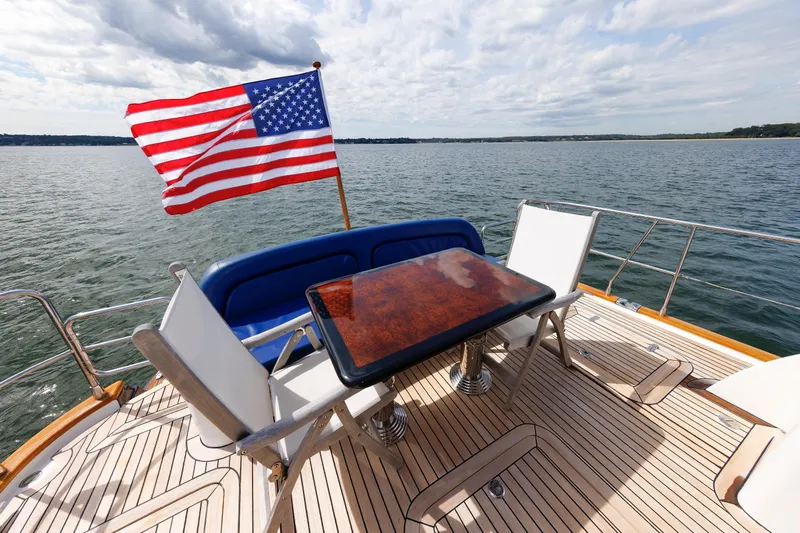 Independence Yacht Photos Pics 2009 Hunt Yachts 52 Express deck with American flag and seating area on open water.