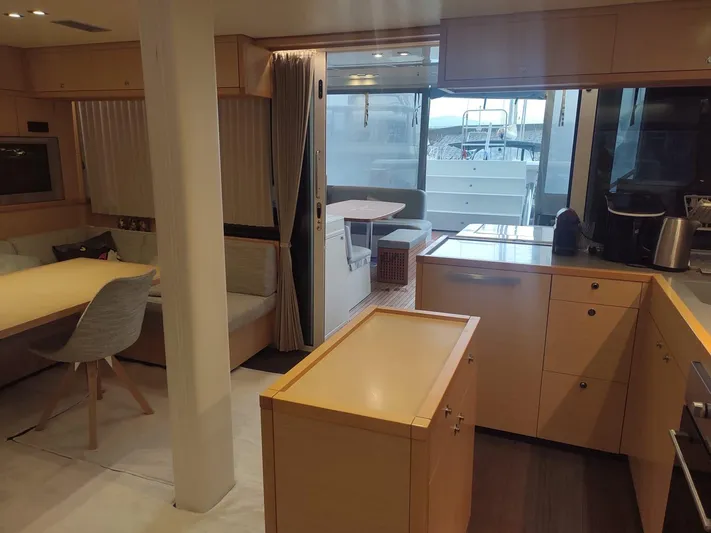 Bada Bing Yacht Photos Pics Luxurious interior of a 2014 Lagoon 52 yacht featuring modern kitchen and dining area.