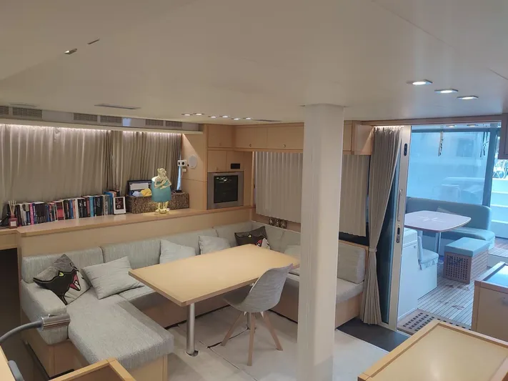 Bada Bing Yacht Photos Pics Interior of 2014 Lagoon 52 yacht with modern seating, dining area, and outdoor access.