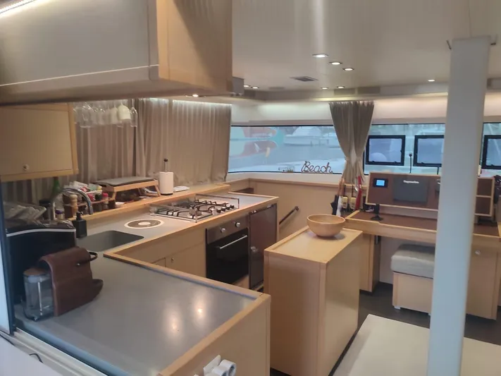 Bada Bing Yacht Photos Pics Luxurious kitchen interior of 2014 Lagoon 52 yacht with modern appliances and sleek design.
