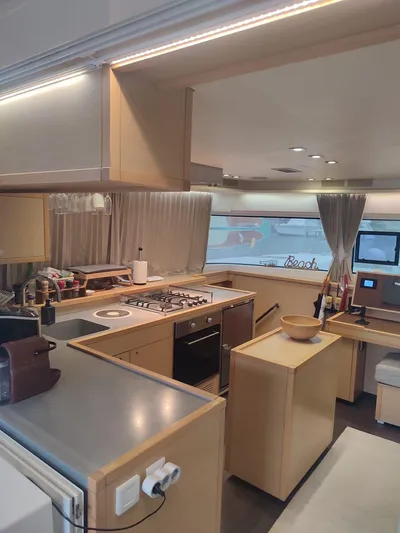 Bada Bing Yacht Photos Pics Interior of 2014 Lagoon 52 yacht featuring modern kitchen with stove and sleek cabinetry.