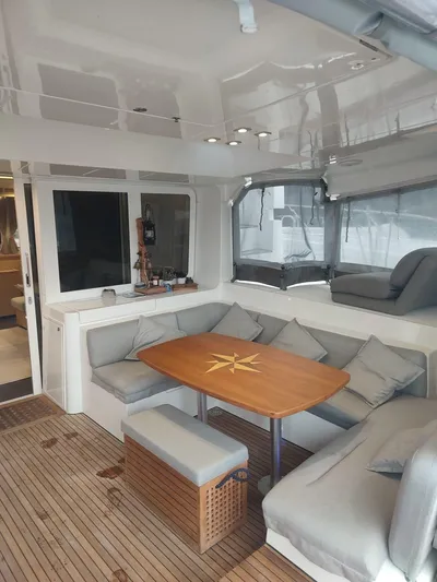 Bada Bing Yacht Photos Pics 2014 Lagoon 52 yacht interior with cozy seating and wooden table.