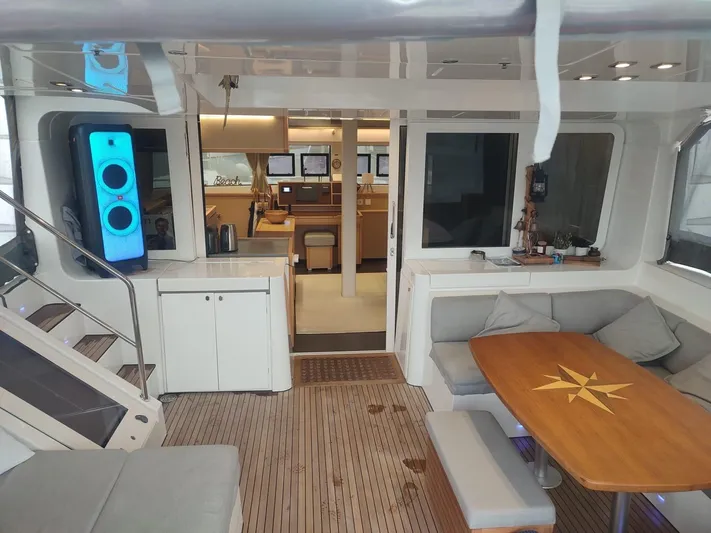 Bada Bing Yacht Photos Pics Luxurious interior of 2014 Lagoon 52 yacht with modern seating and wooden table.