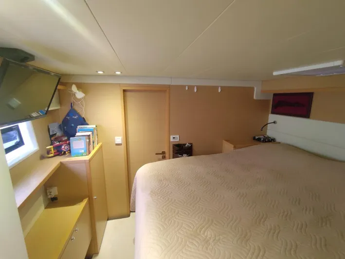 Bada Bing Yacht Photos Pics Luxurious cabin interior of 2014 Lagoon 52 yacht with cozy bed and modern amenities.