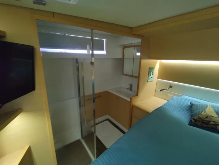 Bada Bing Yacht Photos Pics Luxurious interior of 2014 Lagoon 52 yacht with modern bedroom and ensuite bathroom.