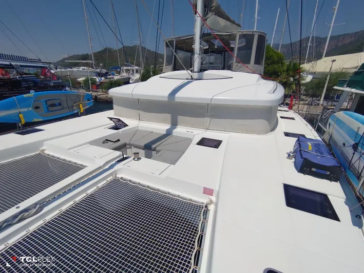 Bada Bing Yacht Photos Pics 2014 Lagoon 52 catamaran deck with netting, docked at marina.
