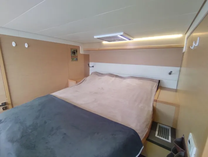 Bada Bing Yacht Photos Pics Luxurious cabin interior of 2014 Lagoon 52 yacht with cozy bed and modern lighting.