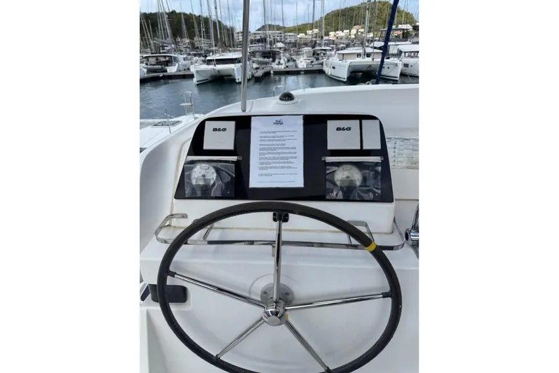  Yacht Photos Pics Helm of 2018 Lagoon 42 catamaran with navigation instruments in marina setting.