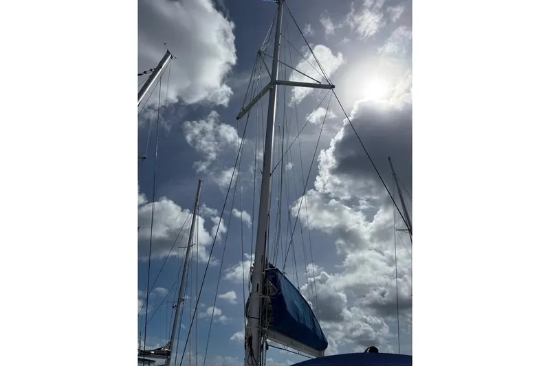  Yacht Photos Pics Sailboat mast of 2018 Lagoon 42 against cloudy sky.