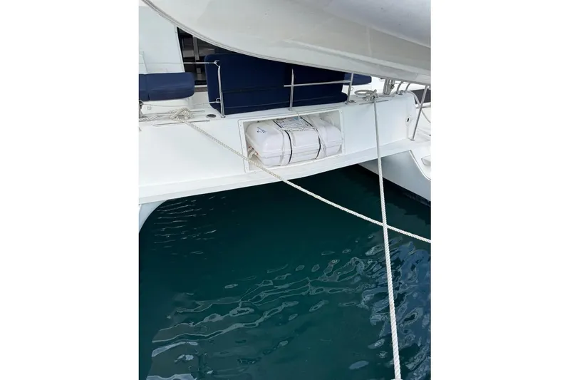  Yacht Photos Pics 2018 Lagoon 42 catamaran stern view with ropes and calm water.