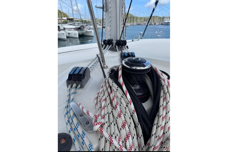  Yacht Photos Pics Close-up of 2018 Lagoon 42 sailboat deck with ropes and winch in marina.