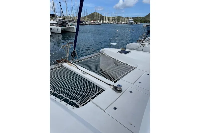  Yacht Photos Pics 2018 Lagoon 42 catamaran docked in a marina, featuring netted deck area.