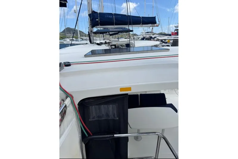 Yacht Photos Pics 2018 Lagoon 42 sailboat deck with seating, docked at marina under blue sky.