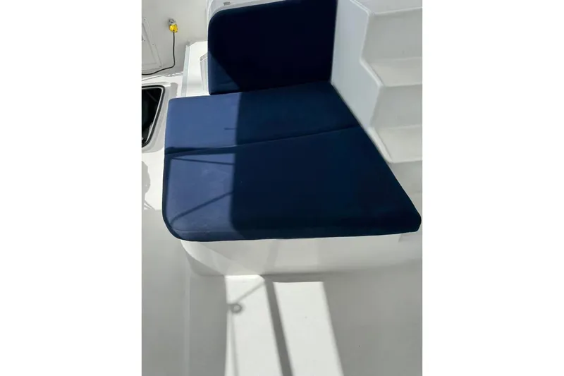  Yacht Photos Pics Blue cushioned seating on 2018 Lagoon 42 yacht deck, with white steps and shadows.