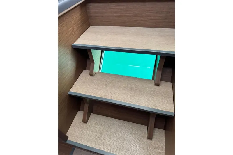  Yacht Photos Pics Wooden stairs with a glass panel on a 2018 Lagoon 42 catamaran.