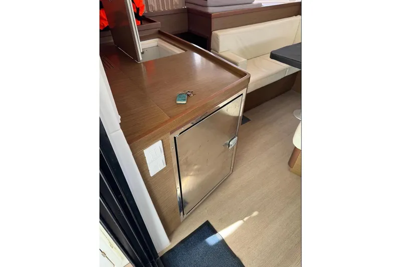  Yacht Photos Pics Interior of 2018 Lagoon 42 yacht with wooden cabinetry and seating area.