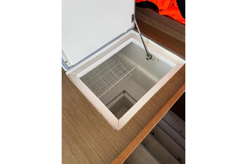  Yacht Photos Pics Open storage compartment on 2018 Lagoon 42 yacht with wooden finish.