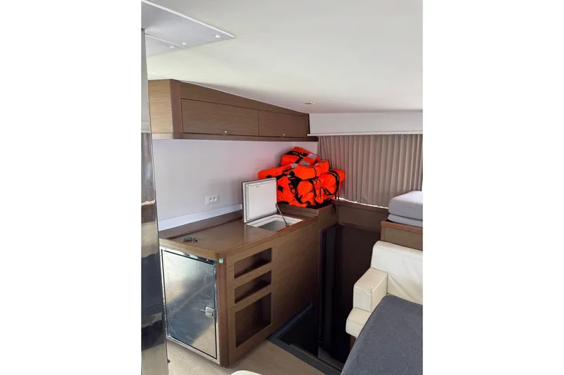  Yacht Photos Pics Interior of 2018 Lagoon 42 yacht with life jackets and compact kitchen area.