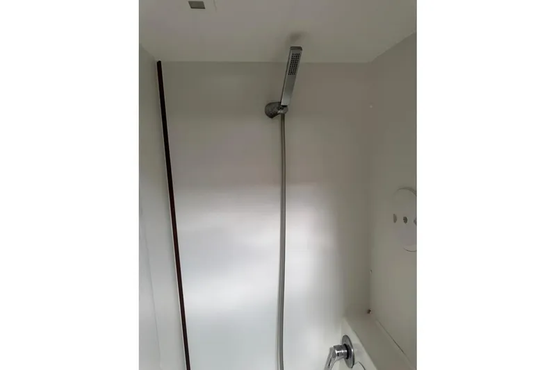  Yacht Photos Pics Shower area inside a 2018 Lagoon 42 yacht, featuring a modern handheld showerhead.