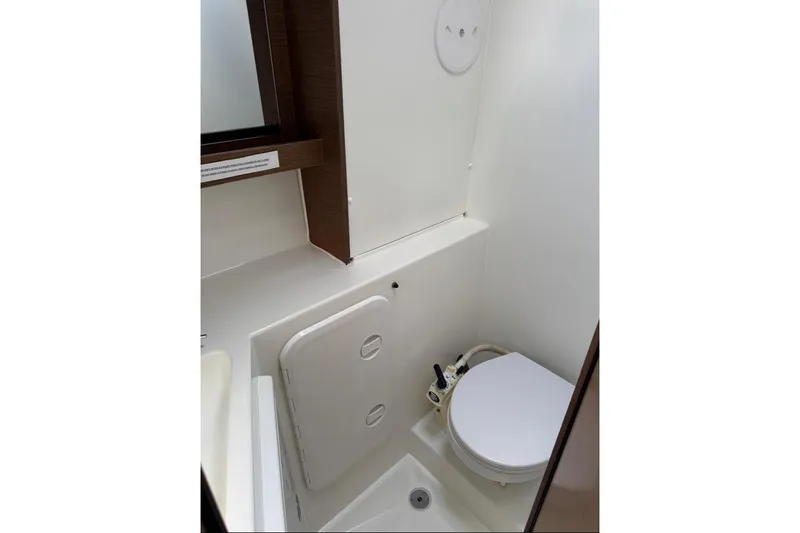  Yacht Photos Pics 2018 Lagoon 42 yacht bathroom with compact toilet and storage.
