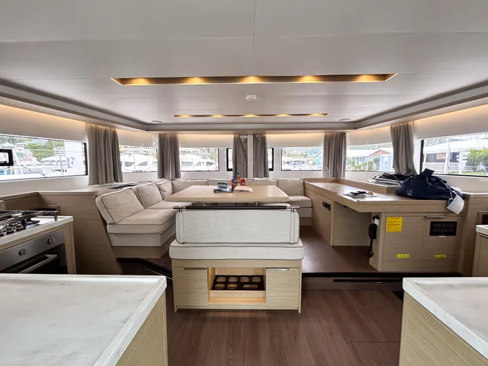 Slinky Malinki Yacht Photos Pics Luxurious interior of 2025 Lagoon 51 yacht with modern furnishings and ample natural light.