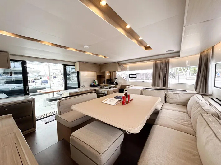 Slinky Malinki Yacht Photos Pics Luxurious interior of 2025 Lagoon 51 yacht with spacious seating and modern design.