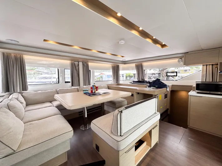 Slinky Malinki Yacht Photos Pics Modern interior of 2025 Lagoon 51 yacht with spacious seating and dining area.