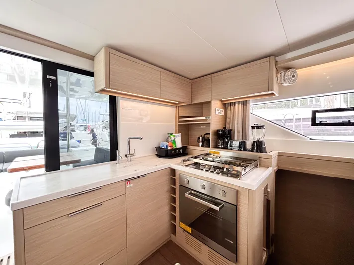 Slinky Malinki Yacht Photos Pics Modern kitchen interior of 2025 Lagoon 51 yacht with sleek appliances and ample natural light.