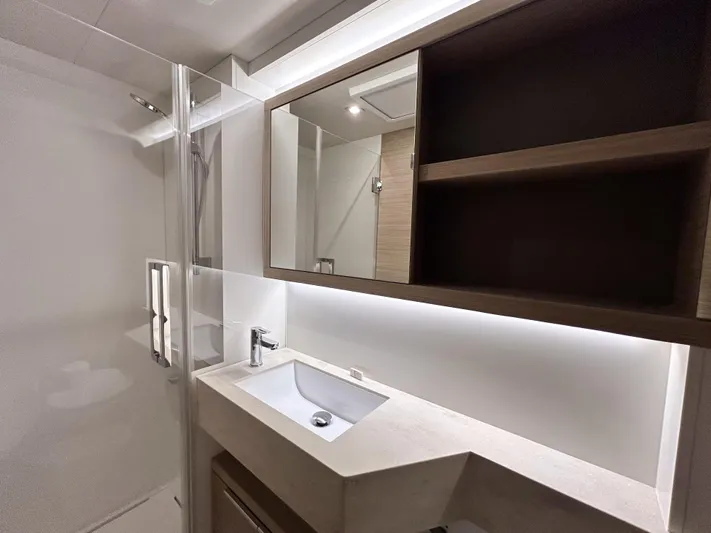 Slinky Malinki Yacht Photos Pics Modern bathroom interior of 2025 Lagoon 51 yacht with sleek sink and mirror.