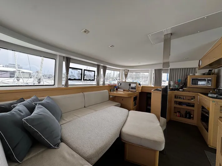 Nellie Yacht Photos Pics Interior of 2020 Lagoon 42 catamaran with modern furnishings and panoramic windows.