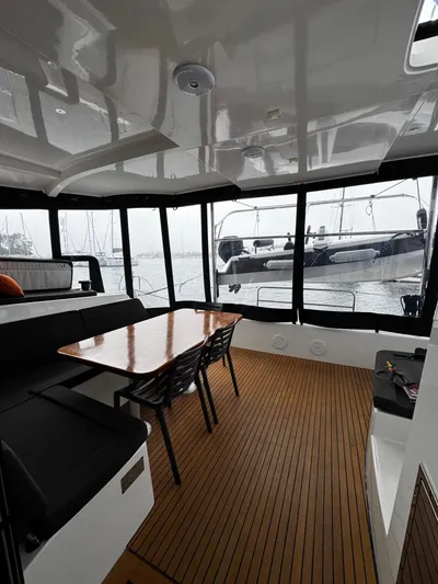 Nellie Yacht Photos Pics Interior of 2020 Lagoon 42 catamaran with wooden flooring and dining area.