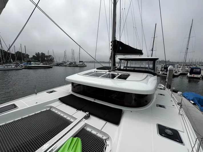 Nellie Yacht Photos Pics 2020 Lagoon 42 catamaran docked in a marina on a cloudy day.
