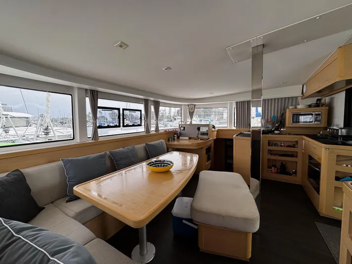 Nellie Yacht Photos Pics Spacious interior of 2020 Lagoon 42 catamaran with modern kitchen and dining area.