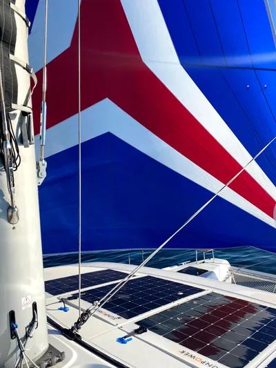 Nellie Yacht Photos Pics Lagoon 42 catamaran with vibrant sail and solar panels, 2020 model.