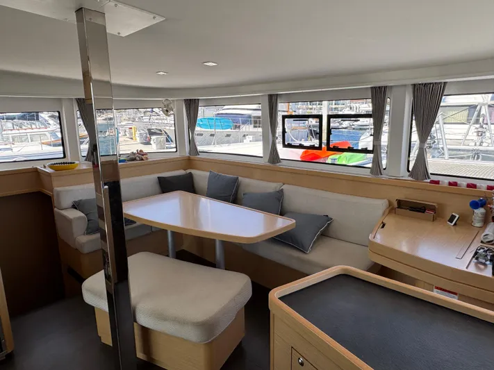 Nellie Yacht Photos Pics Interior of 2020 Lagoon 42 catamaran with modern seating and large windows.