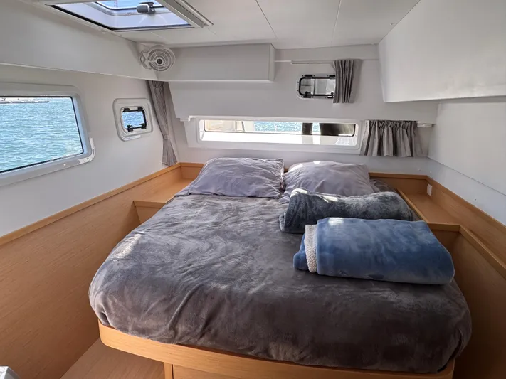 Nellie Yacht Photos Pics Cozy bedroom in 2020 Lagoon 42 catamaran with plush bedding and ocean view.