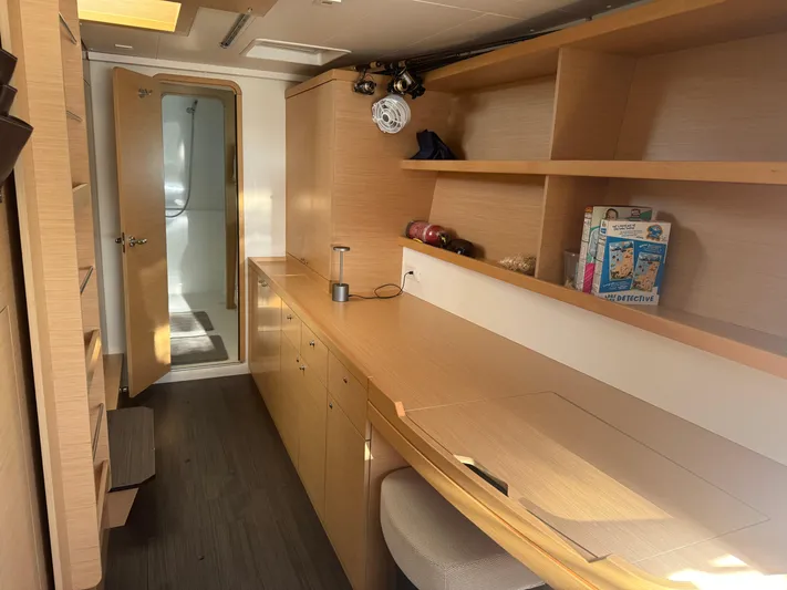 Nellie Yacht Photos Pics Interior of 2020 Lagoon 42 yacht with wooden cabinetry and open shelving.