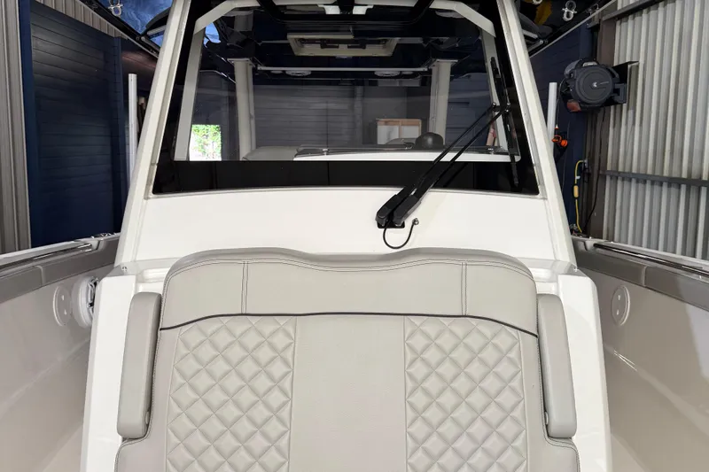  Yacht Photos Pics 2022 Pursuit S 328 Sport boat interior with quilted seating and windshield wiper.