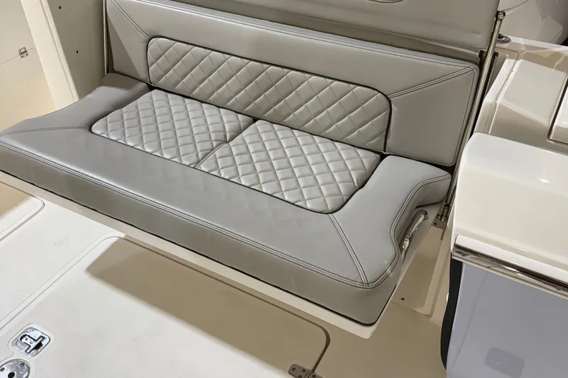  Yacht Photos Pics 2022 Pursuit S 328 Sport boat seat with quilted gray upholstery.
