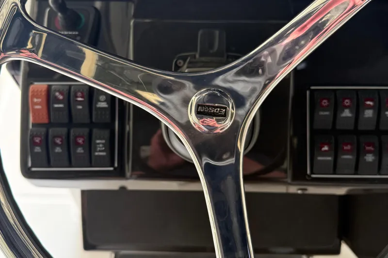  Yacht Photos Pics Steering wheel and control panel of 2022 Pursuit S 328 Sport boat.