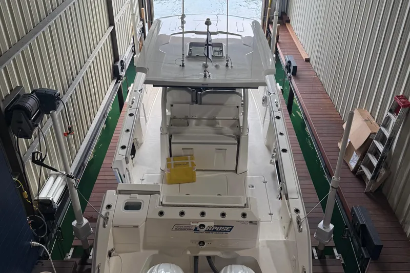  Yacht Photos Pics 2022 Pursuit S 328 Sport boat docked in a covered marina.