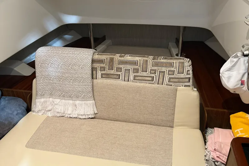  Yacht Photos Pics Interior of 2022 Pursuit S 328 Sport boat with cozy seating and decorative throw.