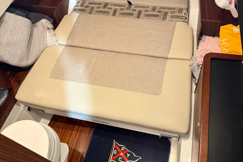  Yacht Photos Pics Interior cabin of 2022 Pursuit S 328 Sport boat with beige seating and nautical decor.
