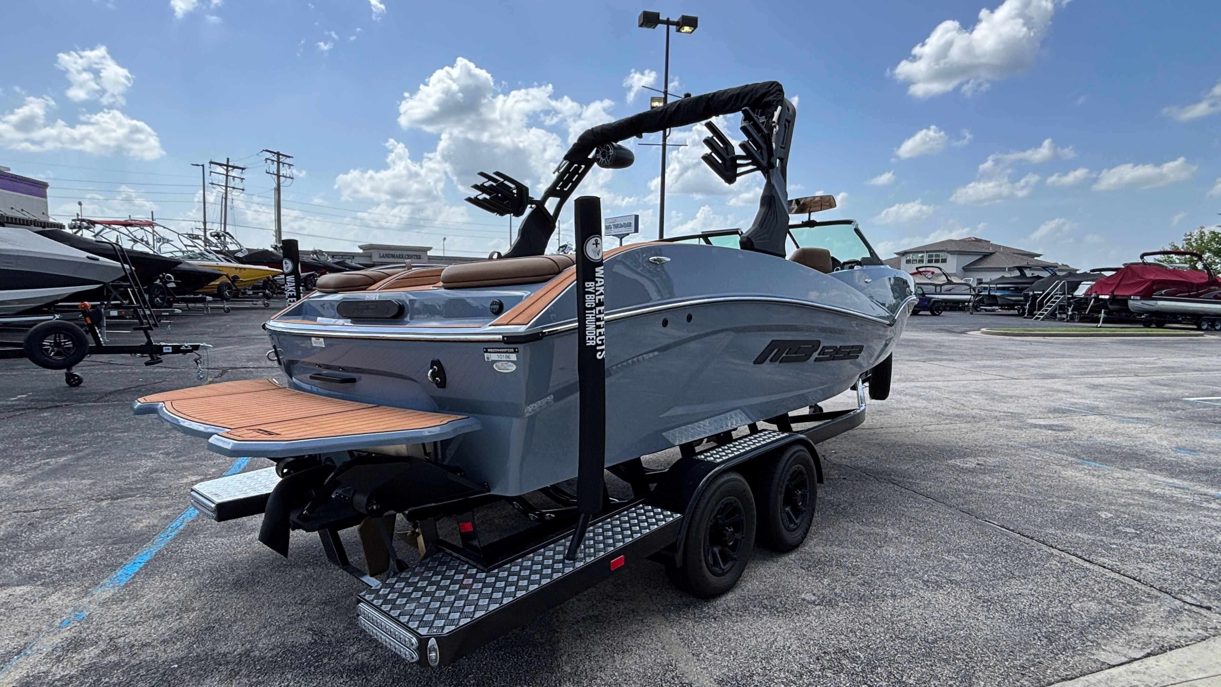 2025 MB B52 23 Alpha boat on trailer under a clear blue sky.