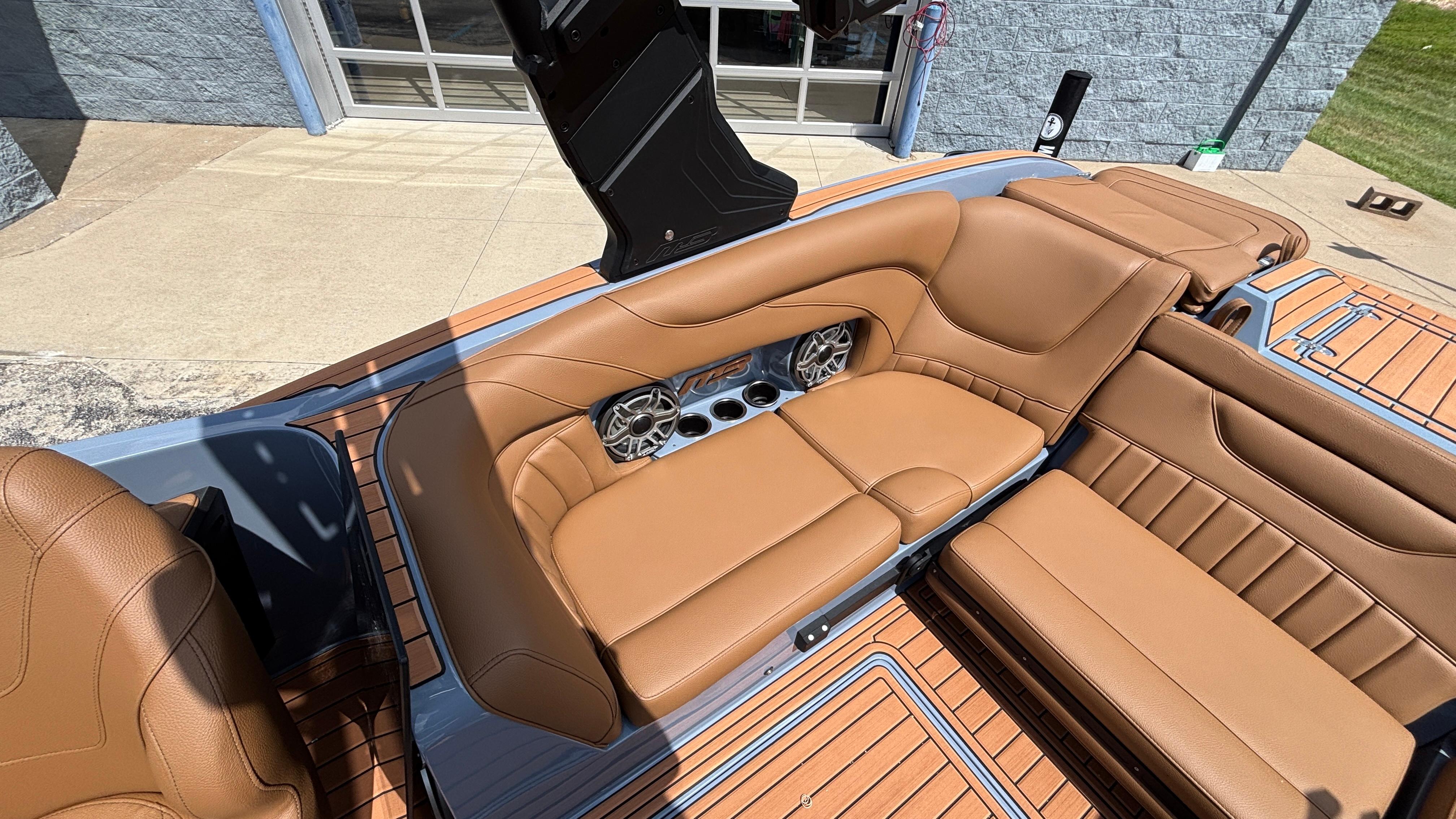 Luxurious tan leather seating in 2025 MB B52 23 Alpha boat, featuring built-in speakers.