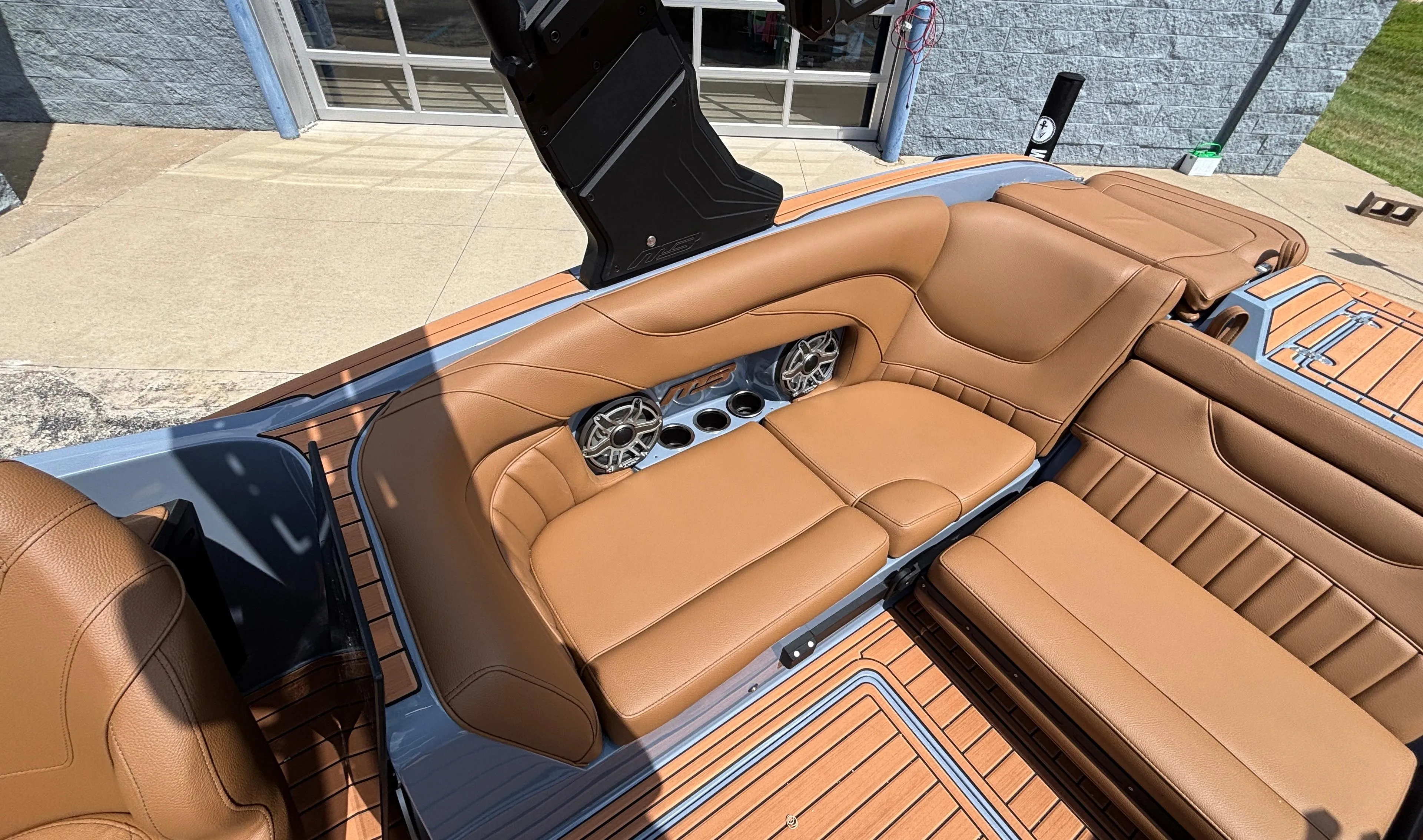 Luxurious tan leather seating in 2025 MB B52 23 Alpha boat, featuring built-in speakers.