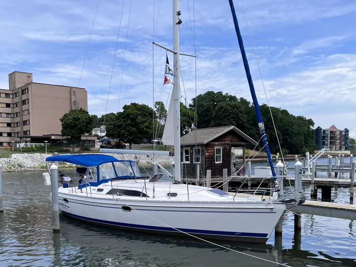 Amadeus Yacht Photos Pics 2014 Catalina 355 sailboat docked at a marina with blue canopy and clear sky.