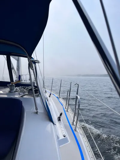 Amadeus Yacht Photos Pics Sailing on a 2014 Catalina 355 yacht in calm waters under a cloudy sky.